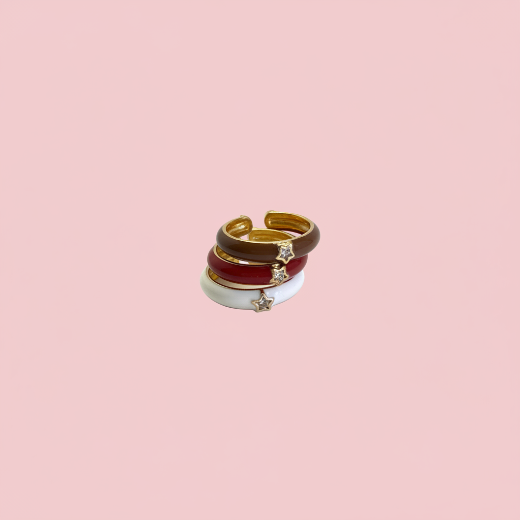 Anillos esmalte dorado fondo rosa